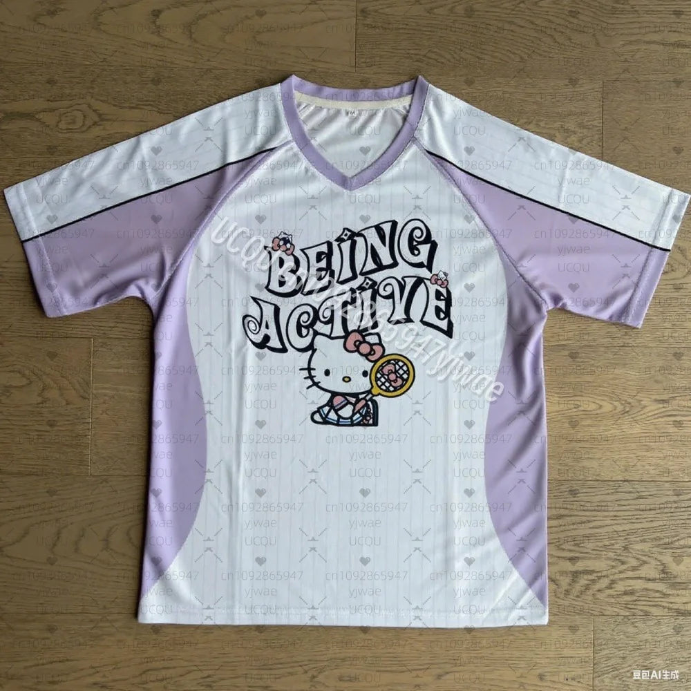 White and purple sports jersey with 'Being Active' text and Hello Kitty graphic on a wooden surface