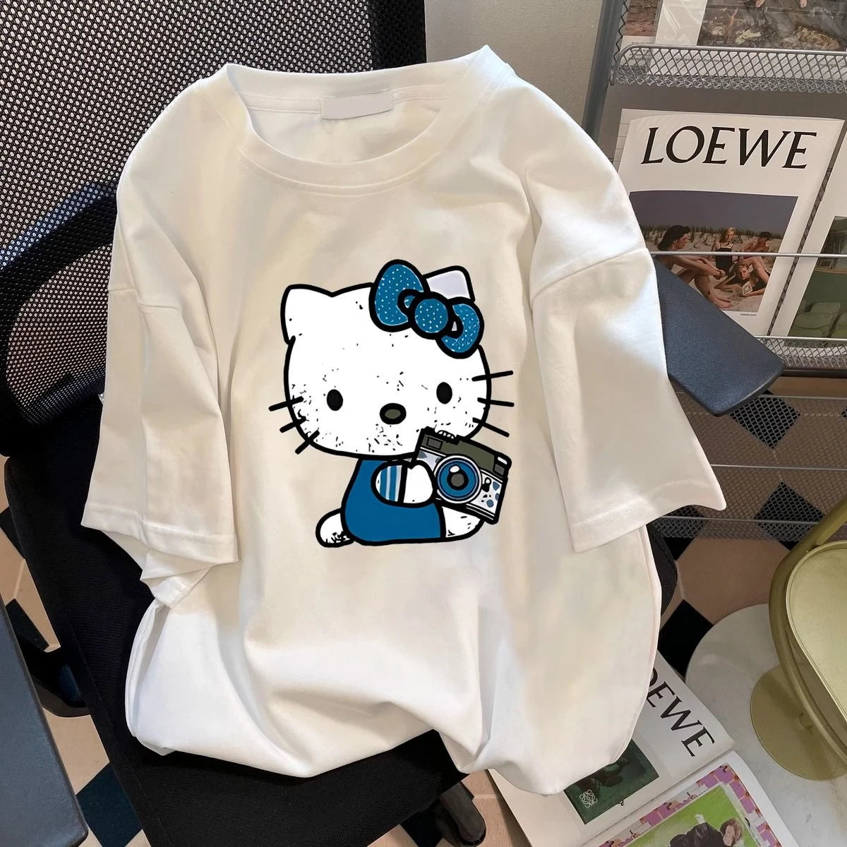 White t-shirt with cartoon character design on a chair