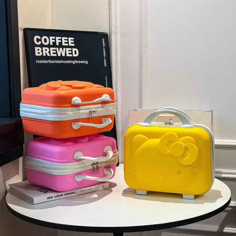 Three colorful small suitcases on a table with a book in the background.