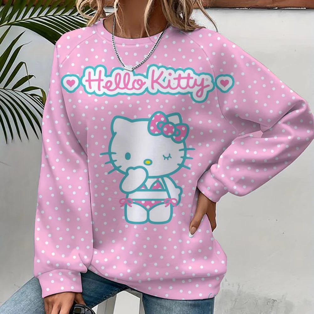 Pink 'Hello Kitty' sweatshirt with white polka dots worn by a person.