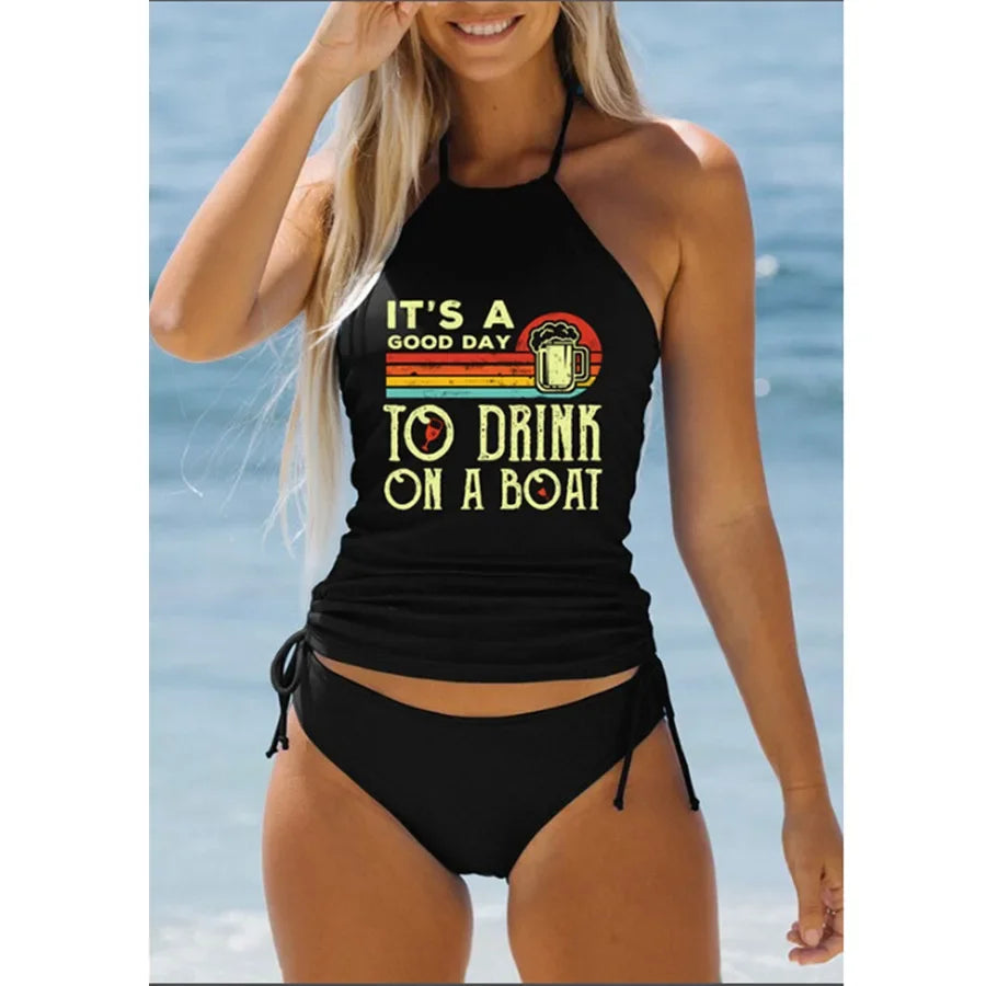 Woman wearing a black swimsuit with a humorous graphic and text on a beach.