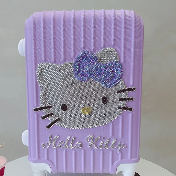 Purple suitcase with Hello Kitty design on a white surface