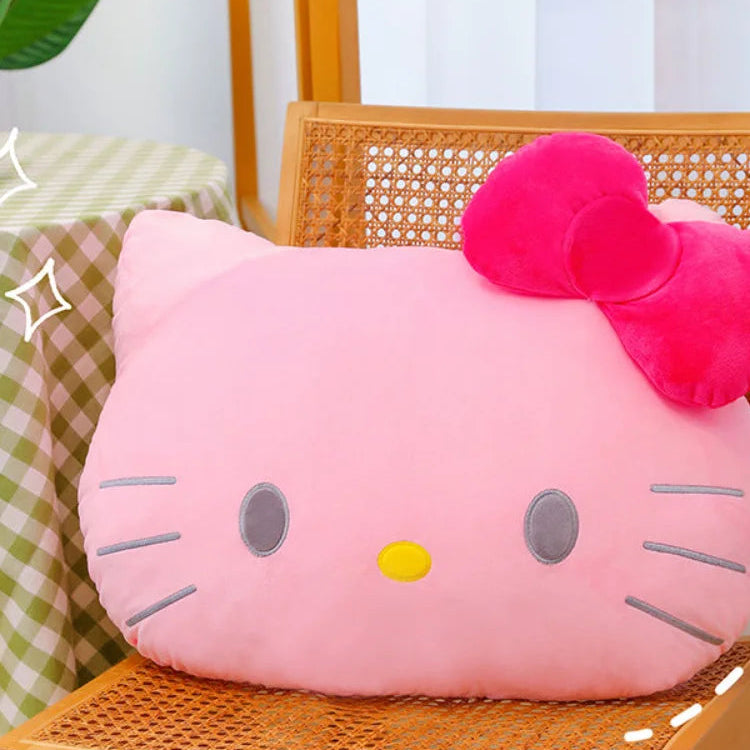 Pink cat-shaped cushion with a yellow nose on a wooden chair