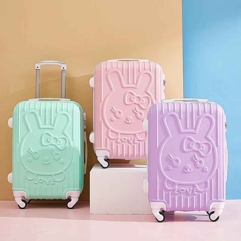 Three colorful suitcases with bunny designs on a multicolored background