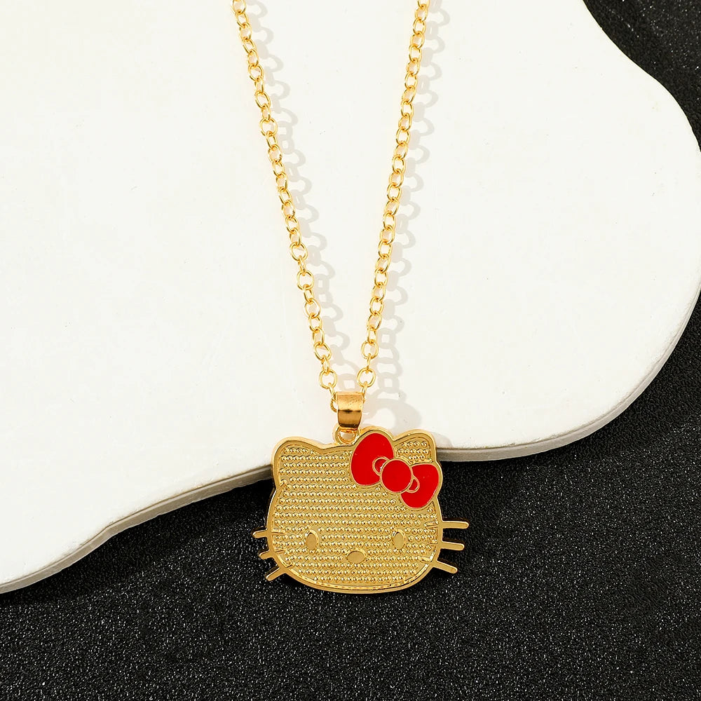 Gold Hello Kitty pendant necklace on a white and black background
