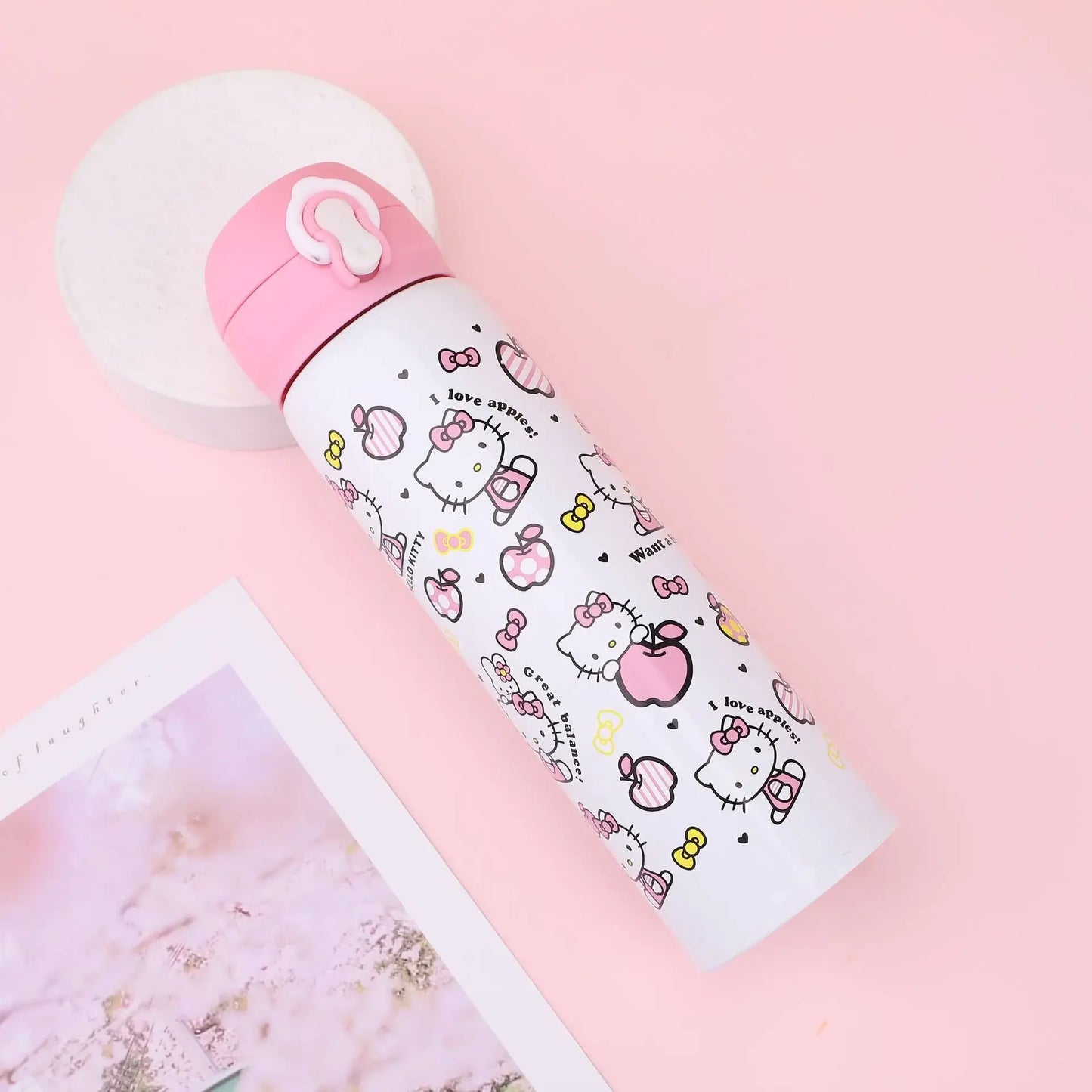 Hello Kitty-themed water bottle on a pink background