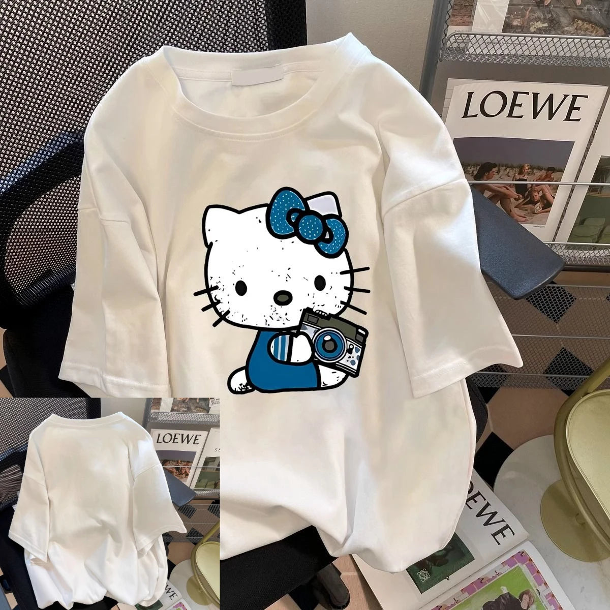 White t-shirt with cartoon character design on a chair with LOEWE magazine in the background
