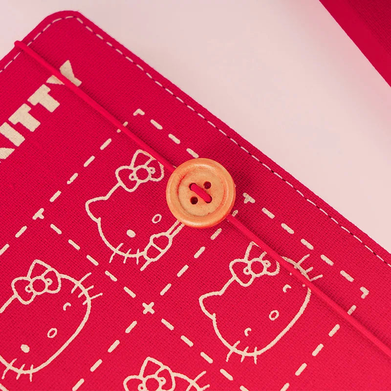 Red fabric with white Hello Kitty patterns and a button, on a red and white background.
