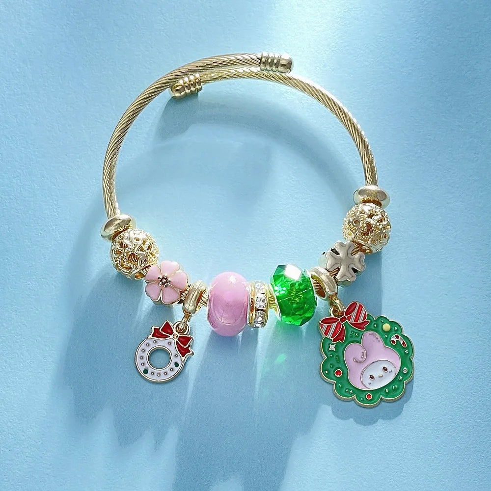 Gold bracelet with colorful beads and charms on a light blue background