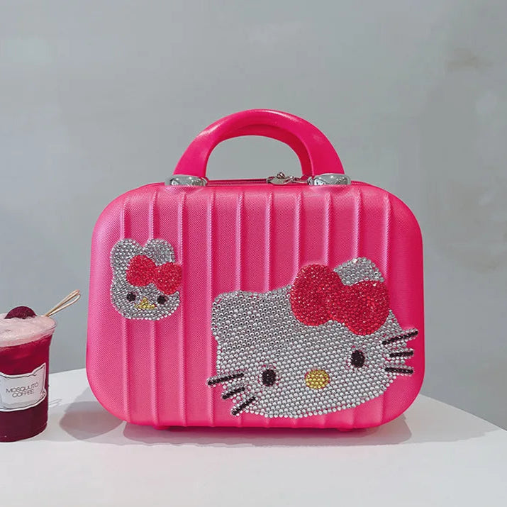 Pink Hello Kitty suitcase with a cup of ice cream on a white surface