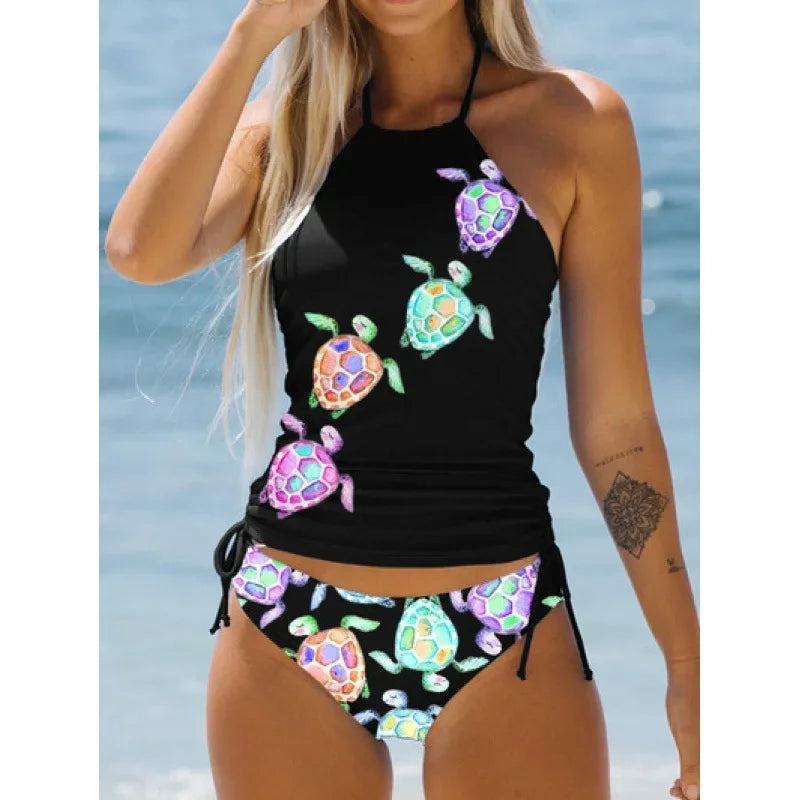 Black bikini with colorful turtle designs against a beach background