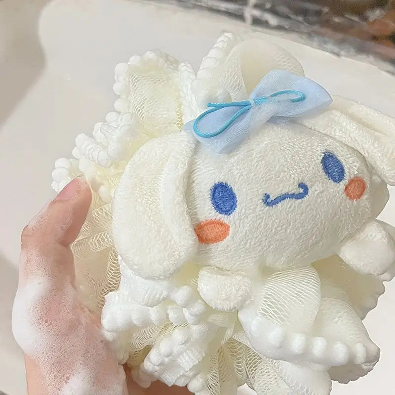 White kitty bath sponge plush toy with a blue bow and colorful face on a white background