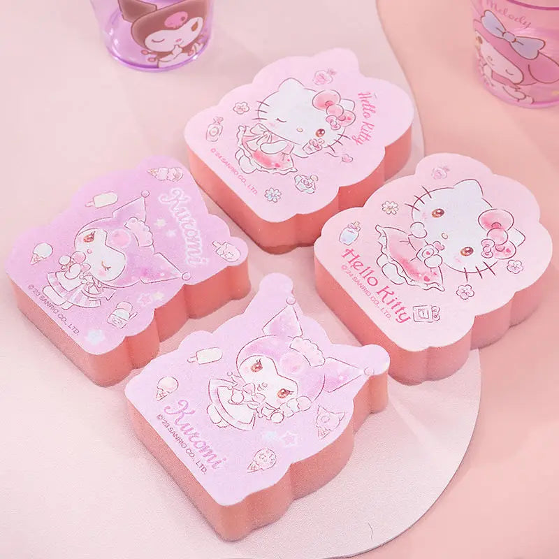 Pink and white Hello Kitty-themed sponges on a light pink background