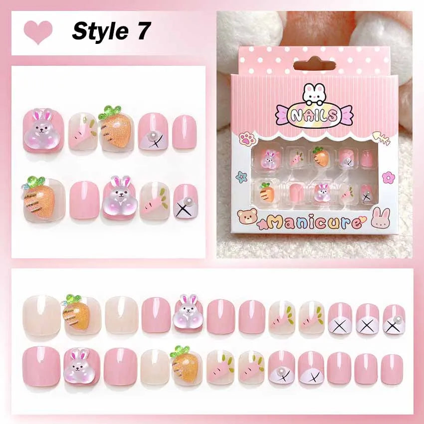Set of cartoon-themed false nails with packaging on a pink background