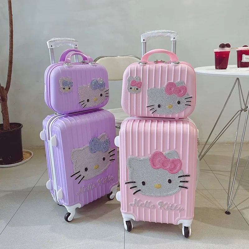 Set of pink and purple Hello Kitty suitcases on a light-colored floor.