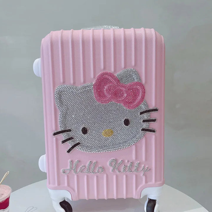 Pink suitcase with Hello Kitty design on a white surface