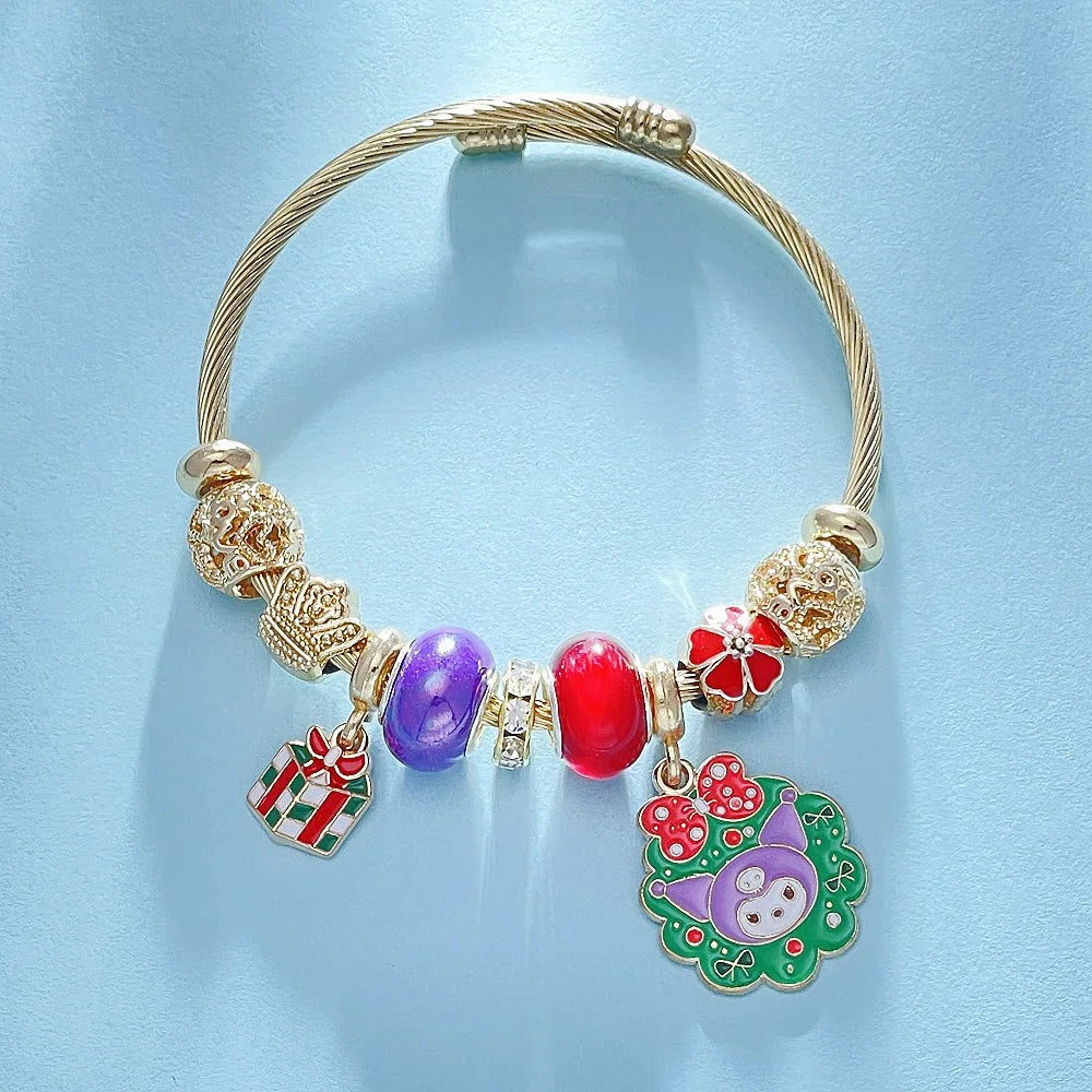Gold bracelet with colorful charms on a light blue background