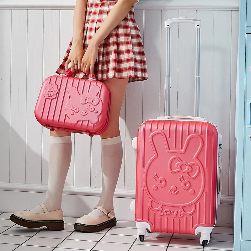 Person holding a pink suitcase with a bunny design in a room.