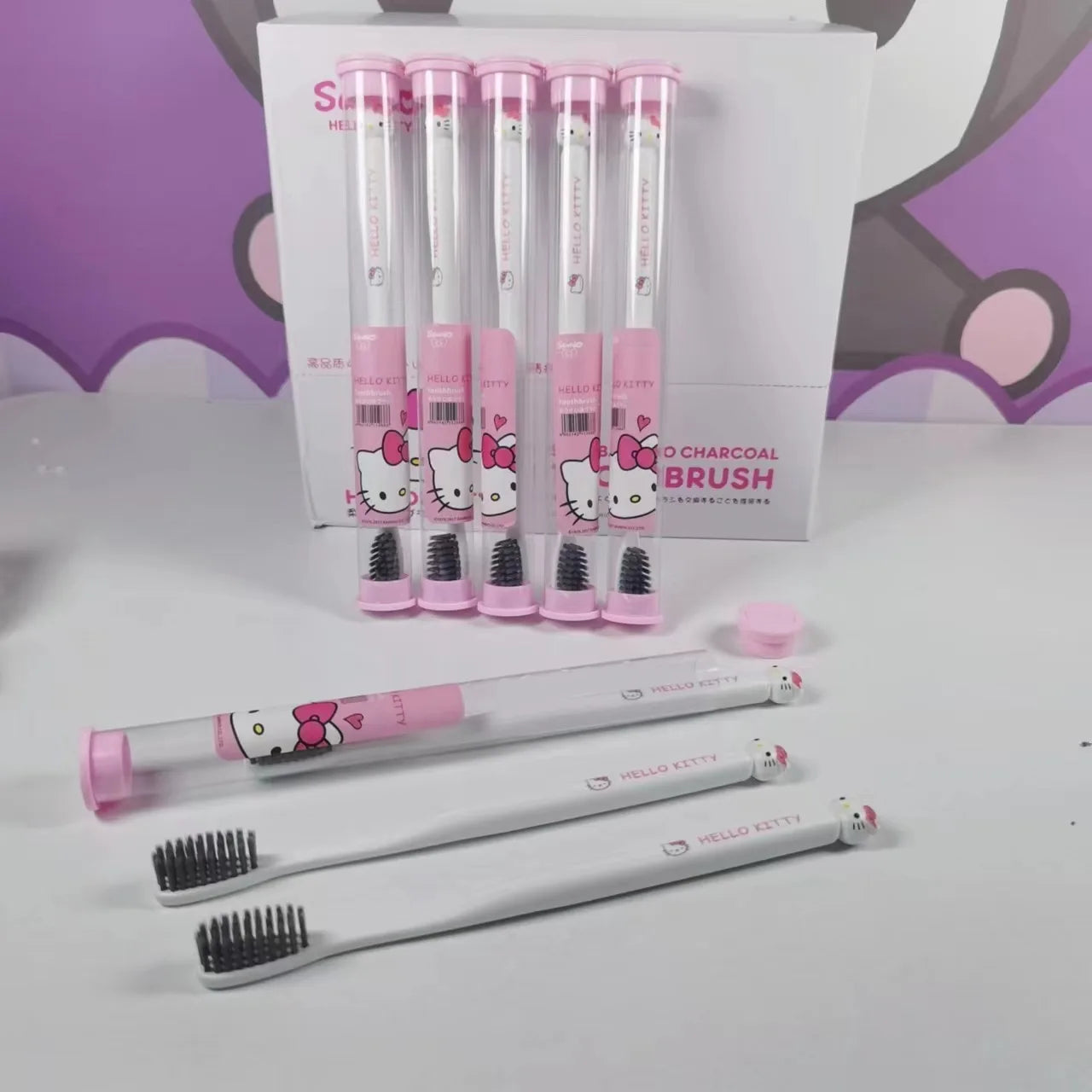 Set of Hello Kitty-themed toothbrushes with packaging in the background.