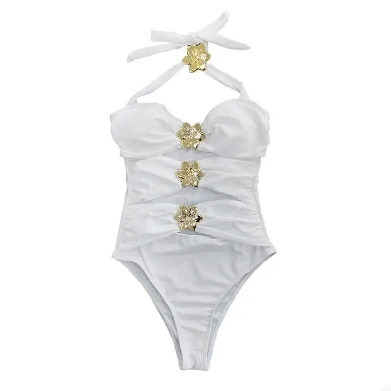 White swimsuit with gold floral embellishments on a white background
