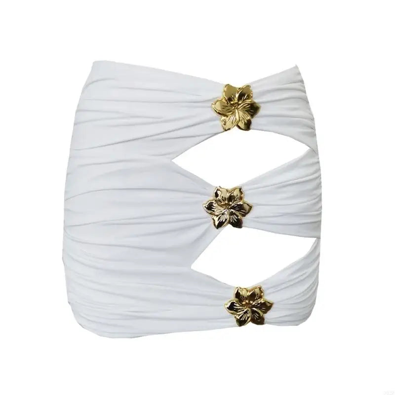 White pleated top with gold floral embellishments on a white background