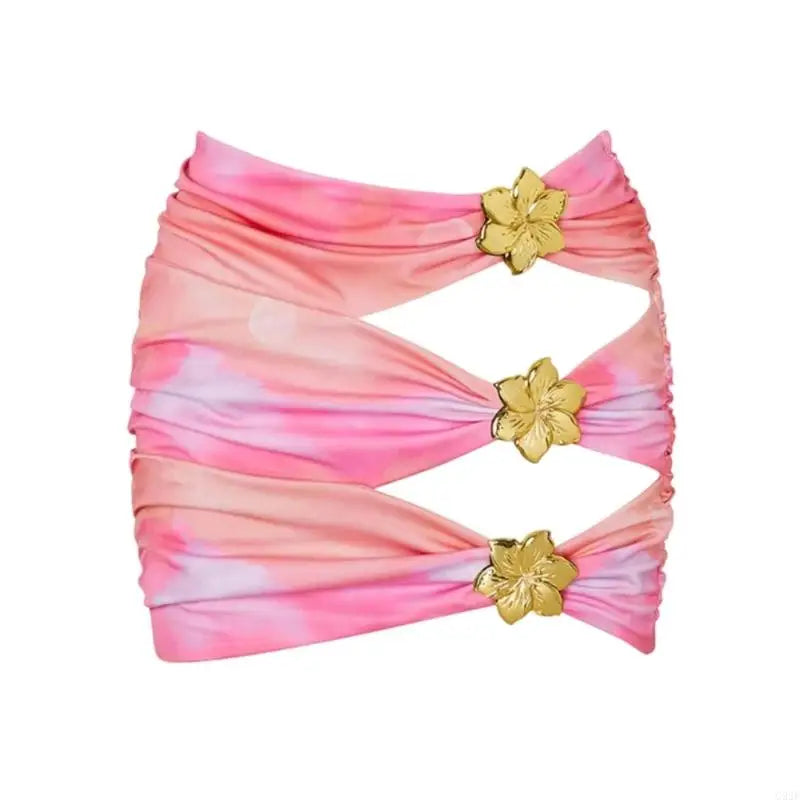 Pink and orange tie-dye headband with gold floral clips on a white background