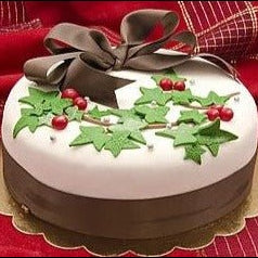 Gluten-free vegan Christmas Jamaican rum fruit cake with white icing and festive decorations - dairy-free holiday dessert
