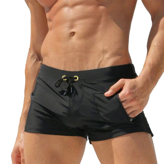Black swim shorts with a drawstring on a white background
