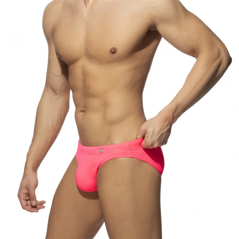 Man wearing Pink swim briefs on a white background