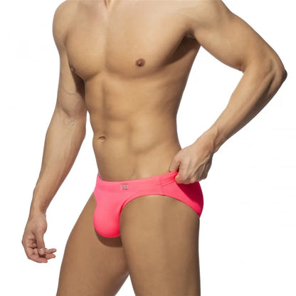 Man wearing Pink swim briefs on a white background