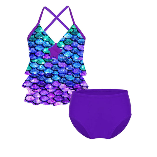 Two-piece swimsuit with mermaid scale top and purple bottom on a white background