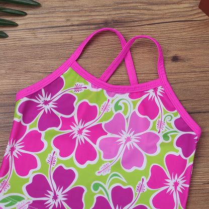 Pink and green floral bikini top on a wooden surface