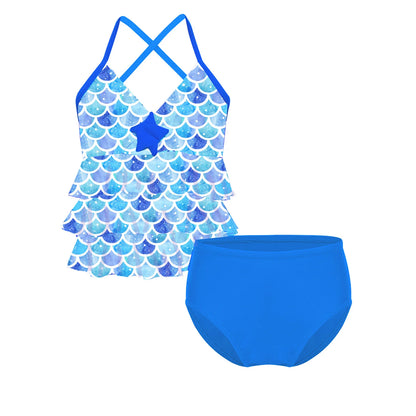 Blue mermaid scale patterned swimsuit with star detail on a white background