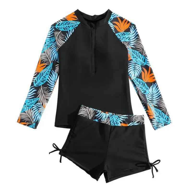 Black swim set with colorful leaf patterns on sleeves and shorts against a white background