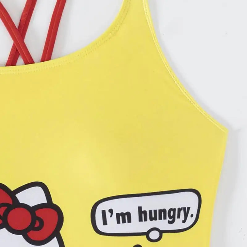 Yellow children's top with cartoon design and text 'I'm hungry' on a white background