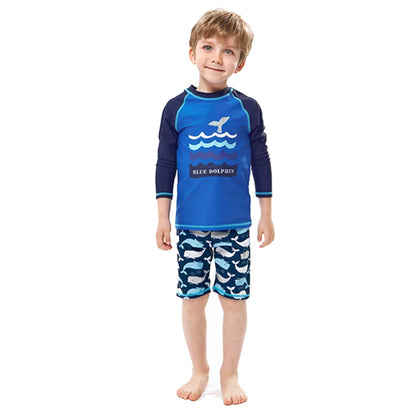 Child wearing a blue and navy swimsuit with whale design on a white background