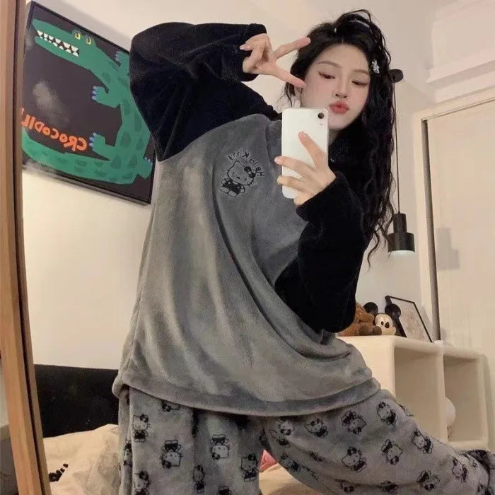 Person wearing gray pajama set with panda design, taking a mirror selfie.