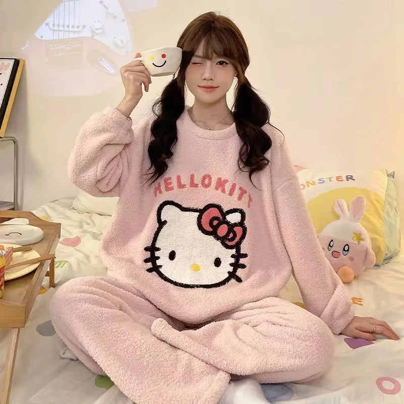 Person wearing a Hello Kitty pajama set holding a smiley face mug.