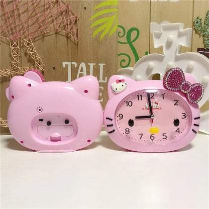 Two pink cartoon clocks, one shaped like a bear and the other like a cat with a bow, on a light background.