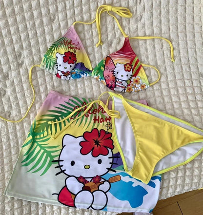 Colorful Hello Kitty bikini set on a textured surface