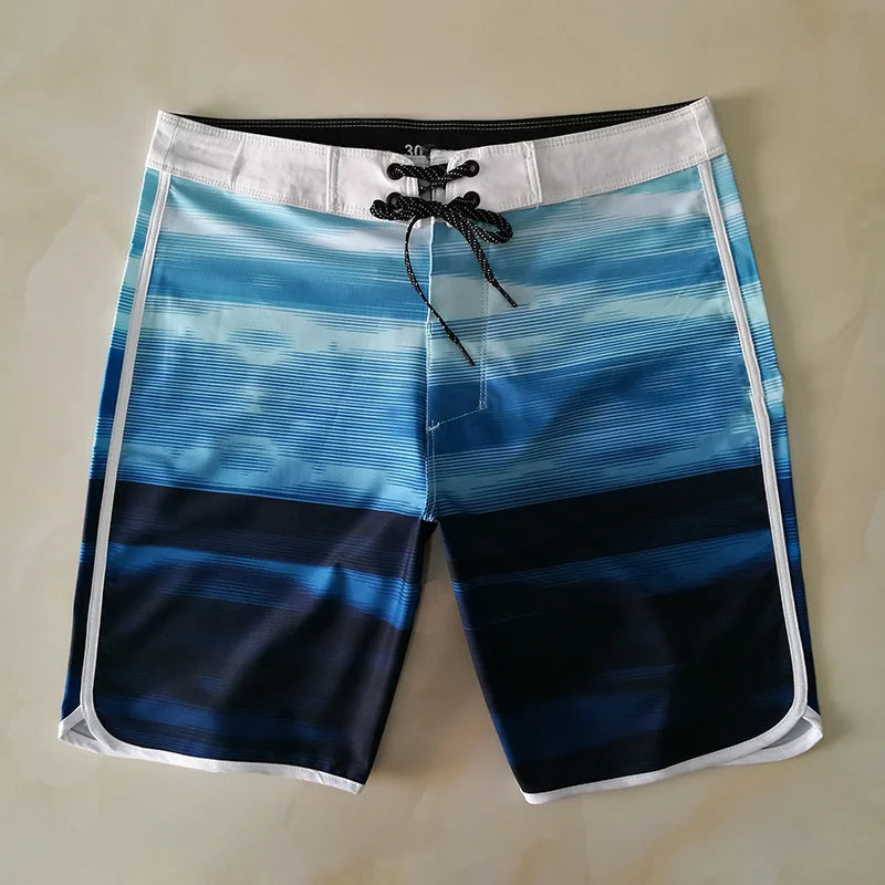 Blue and black striped board shorts on a beige background