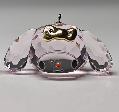 Crystal dog figurine with a gold collar on a gray background
