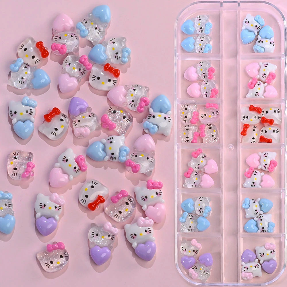 Set of Hello Kitty-themed nail art decorations in a clear organizer on a pink background