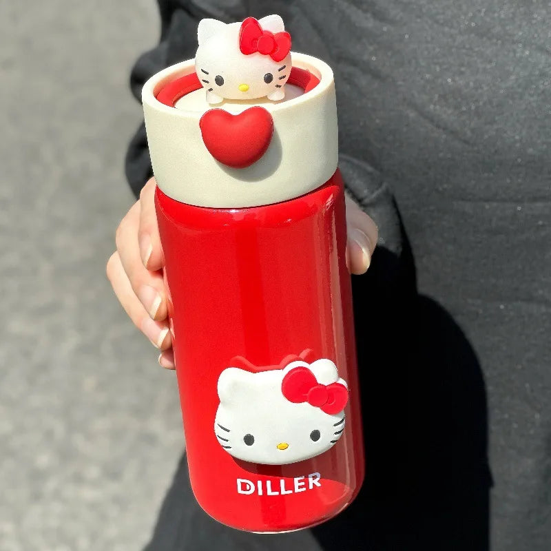 Red water bottle with Hello Kitty design held by a person