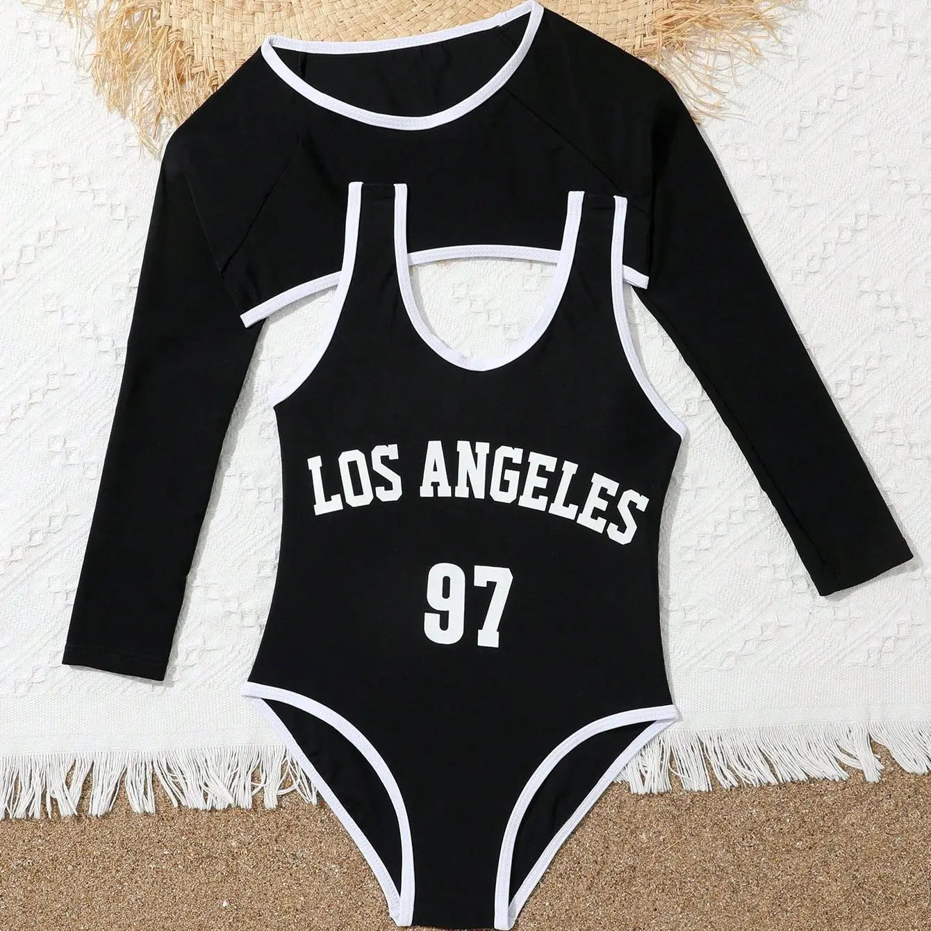 Black swimsuit with 'Los Angeles 97' text on a textured surface