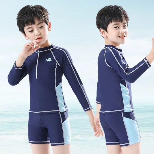 Two children wearing a navy and light blue swimsuit set against a light blue background.