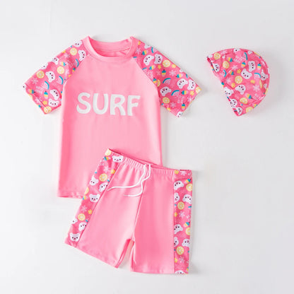 Pink children's swimsuit set with 'SURF' text on a white background