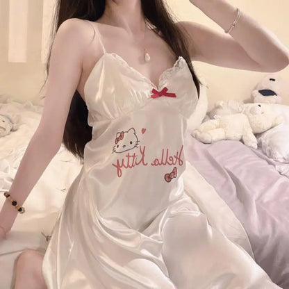 Woman wearing a white nightgown with Hello Kitty design in a bedroom setting.