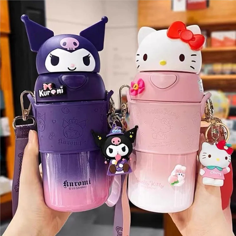 Two cartoon-themed water bottles, one purple with a character on top and one pink with a character on top, held by a person.