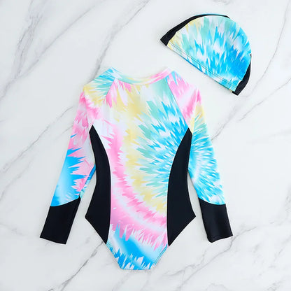 Tie-dye swimsuit with long sleeves and matching cap on a marble surface